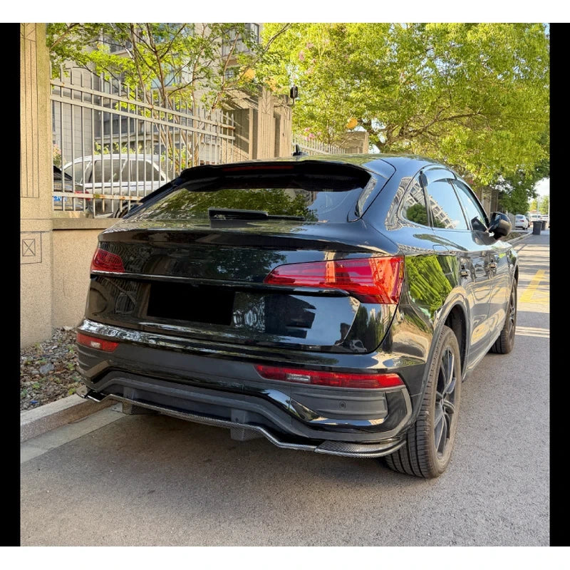 Clean rear three-quarter street view of a 2021-2025 Audi Q5 FY Sportback S-Line wearing the carbon fibre look rear diffuser