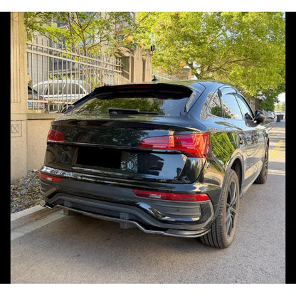 Clean rear three-quarter street view of a 2021-2025 Audi Q5 FY Sportback S-Line wearing the carbon fibre look rear diffuser