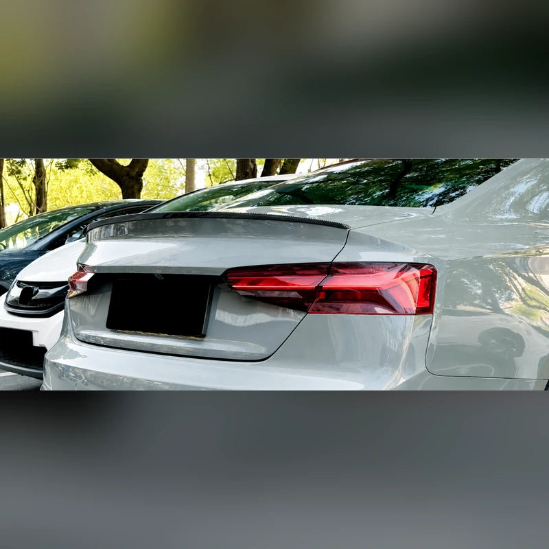 Silver Audi A5 F5 Coupe photographed from the rear three quarter with the S5 style trunk lip spoiler installed.