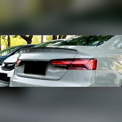 Silver Audi A5 F5 Coupe photographed from the rear three quarter with the S5 style trunk lip spoiler installed.